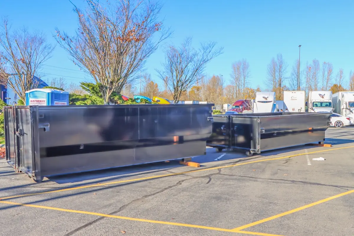 Professional dumpster rental service with roll-off container on residential driveway in Woodbridge